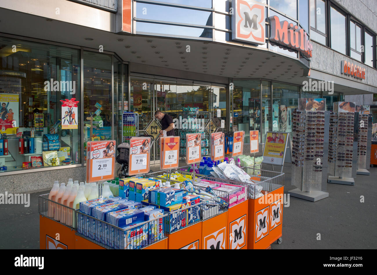 Cleaning and other household products on display in wire baskets outside branch of Müller, Wetzlar, Germany Stock Photo