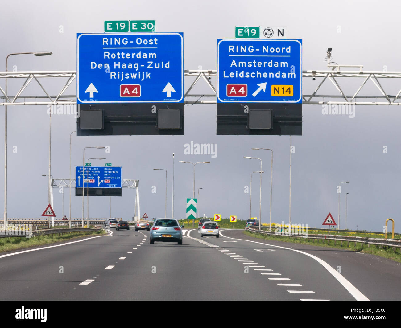 Traffic on motorway A4 and overhead route information signs, The Hague, South Holland, Netherlands Stock Photo