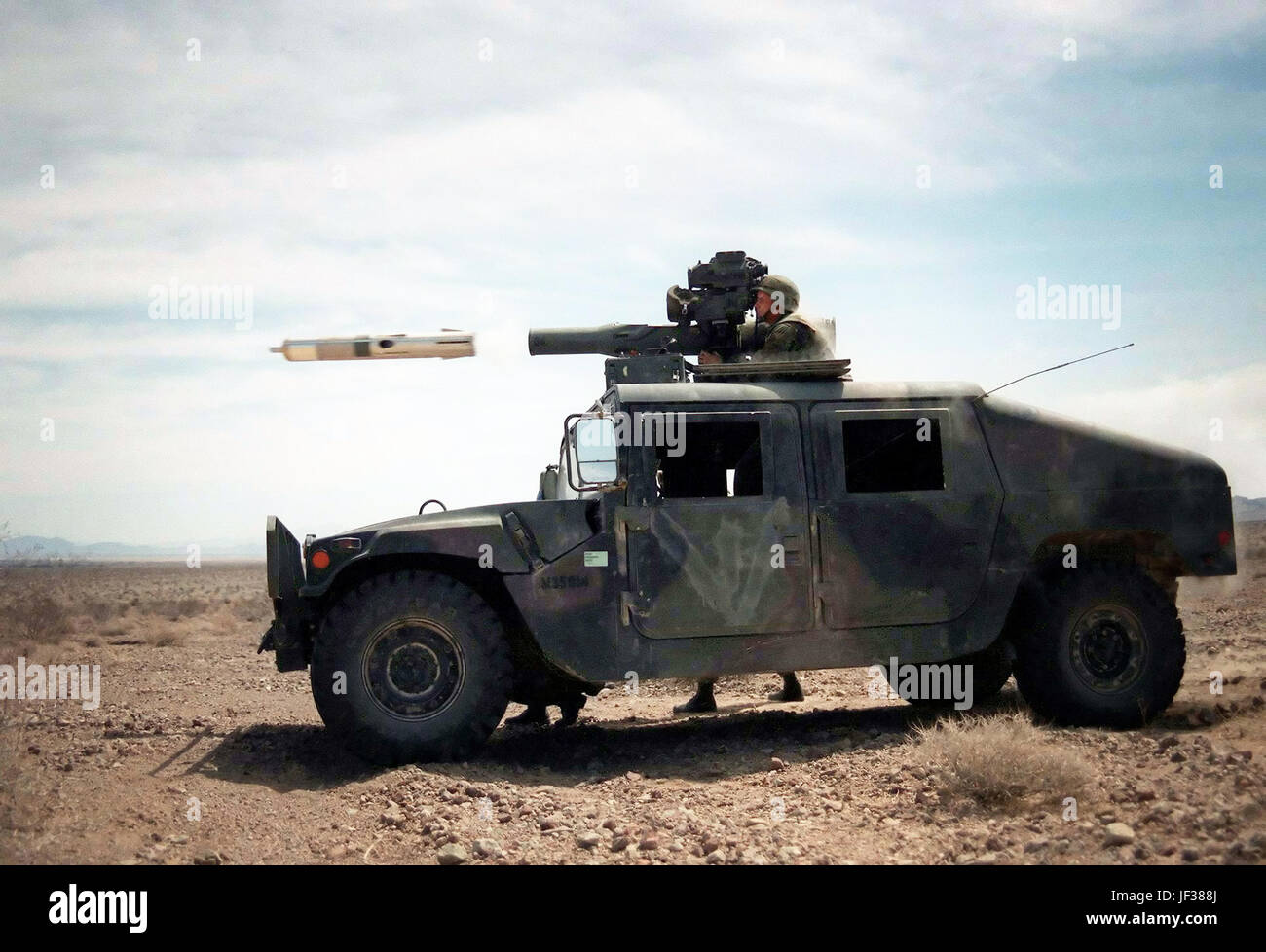 970420-M-8708Y-001 A Tube Launched, Optically Tracked, Wire-guided (TOW) missile hurtles out of its launcher mounted on a U.S. Marine Corps Humvee at the Marine Corps Air Ground Combat Center, Twentynine Palms, Calif., during Combined Arms Exercise 5-97, on April 20, 1997.  The Marine Air Ground Task Force exercise is allowing these Marines of the TOW platoon, Weapons Company, 3rd Battalion, 2nd Marine Regiment, to practice their desert warfare at the Twentynine Palms Lead Mountain Range.  DoD photo by Lance Cpl. E.J. Young, U.S. Marine Corps. Stock Photo