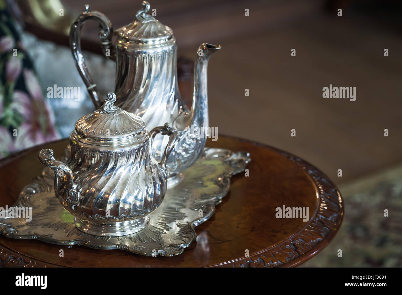 Vintage luxury silver dishware, tea set on wooden table Stock Photo