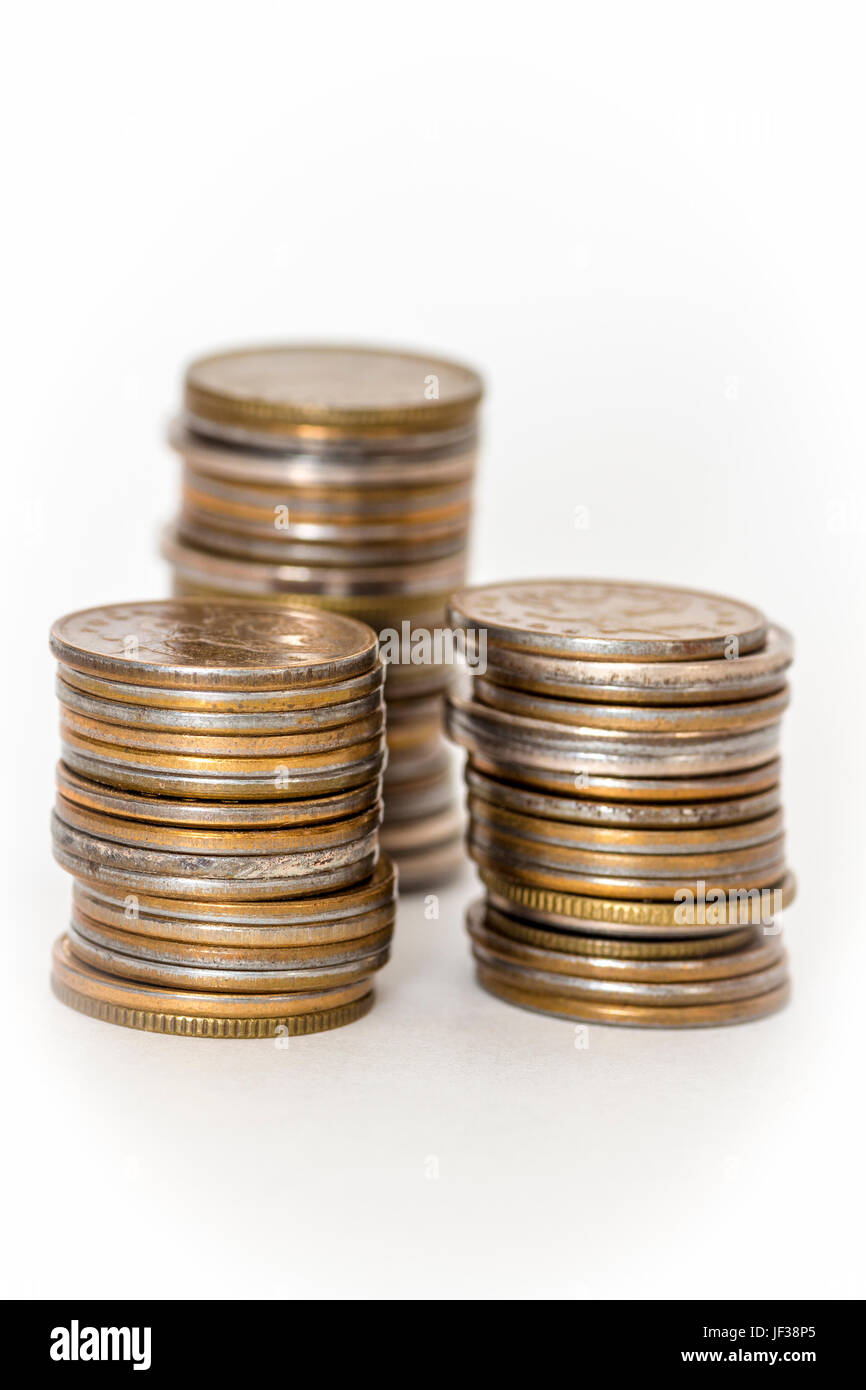 Three stacks of coins close up on white background Stock Photo Alamy