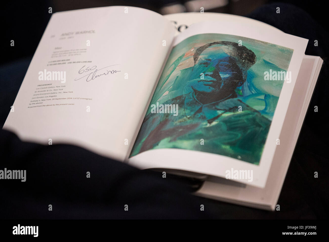 London, UK. 28 June 2017. Sotheby’s Contemporary Art Evening Auction takes place at their New Bond Street premises. View of the Andy Warhol painting of Mao in the auction catalogue. Stock Photo