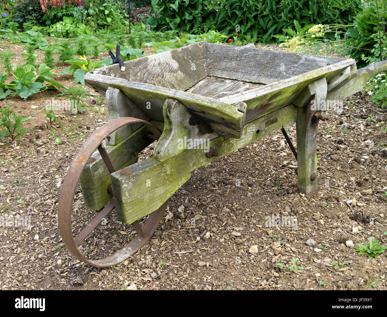 Old wooden garden wheelbarrow Stock Photo