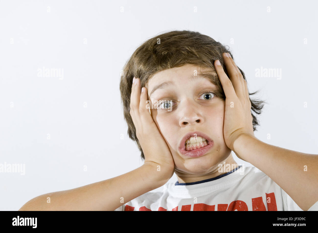 fearful grimacing of boy on white Stock Photo