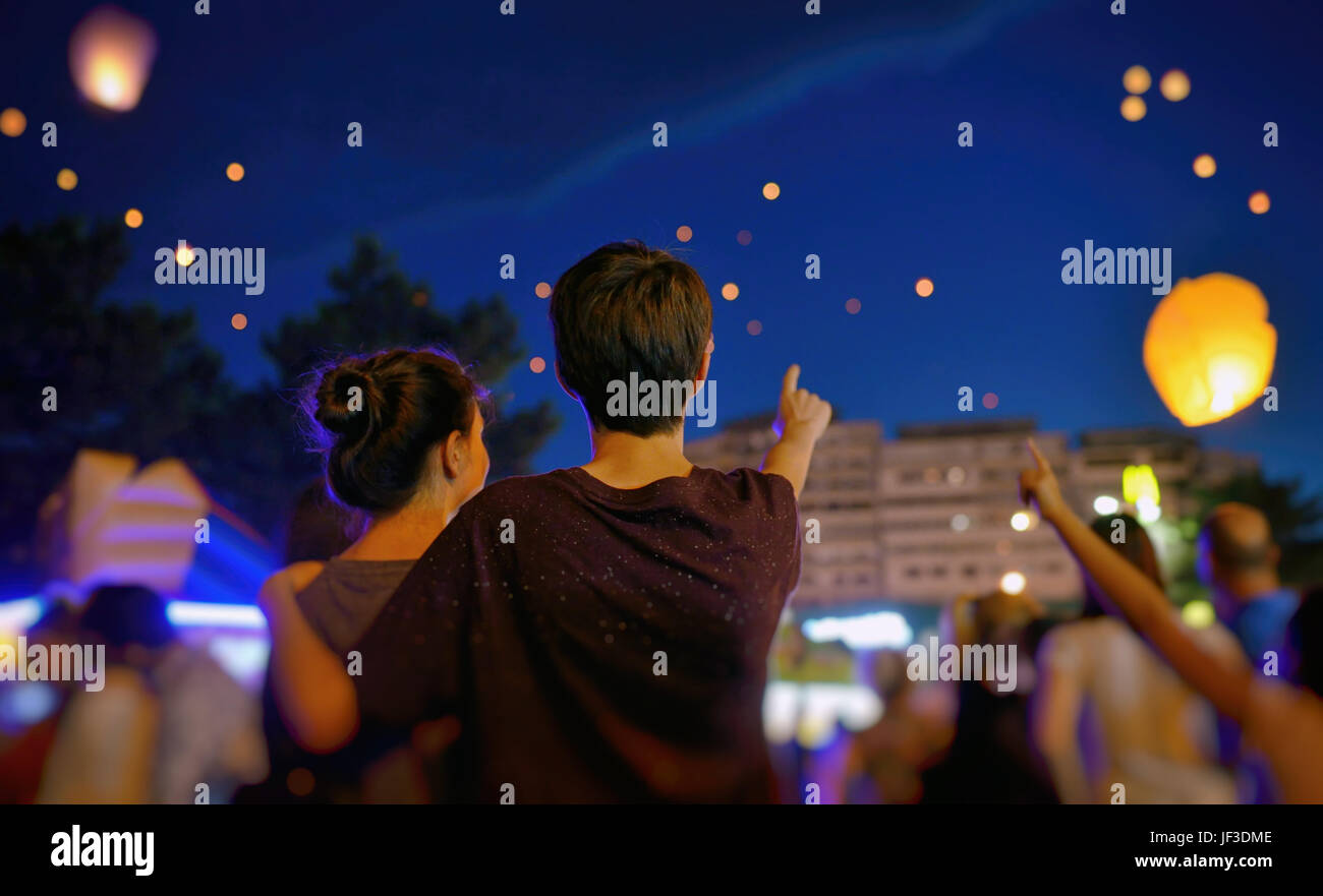 Teens in summer night with paper lantern Stock Photo