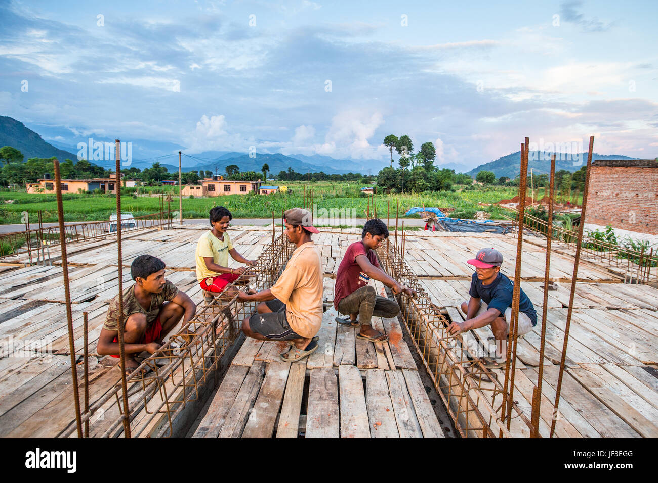 Young men working with rebar when building a home in Nuwakot District, Nepal Stock Photo