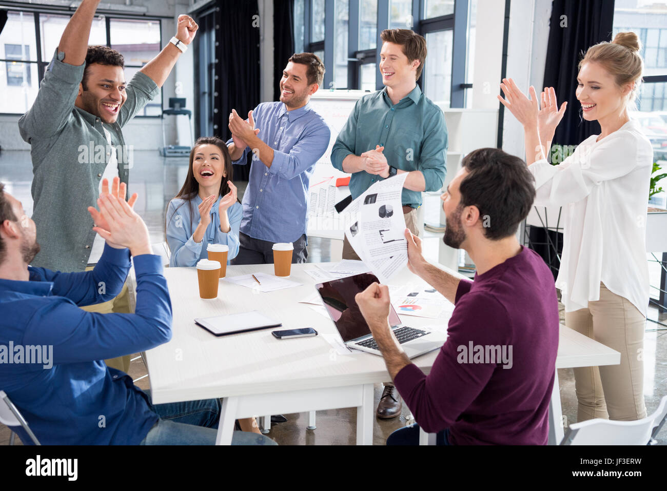 business team celebrating success together on workplace in office, young professional group concept Stock Photo