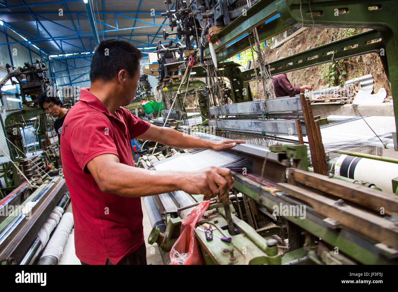 Man working in a textile factory in Kathmandu, Nepal Stock Photo