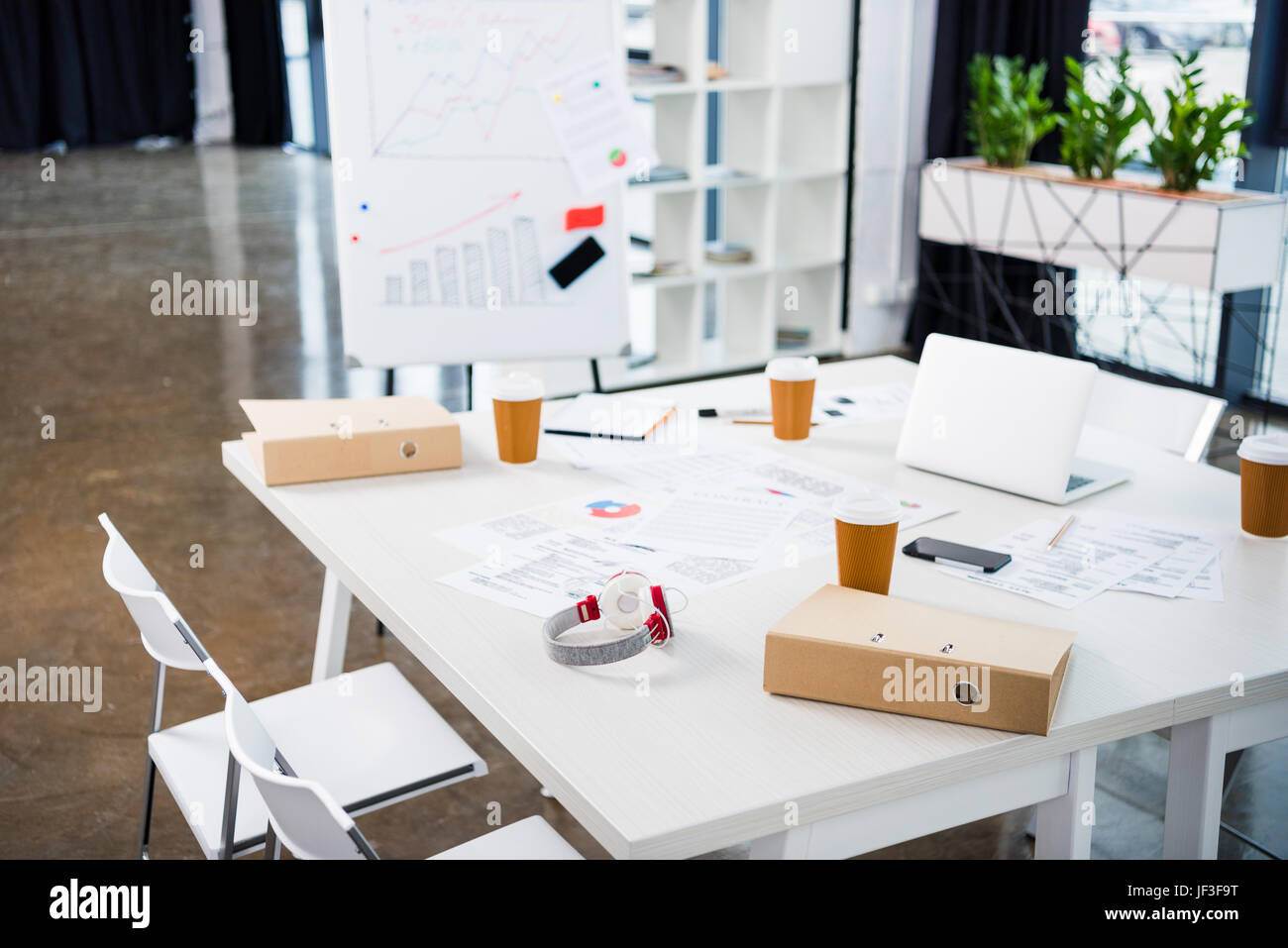 workplace with laptop, coffee paper cups in modern office Stock Photo ...
