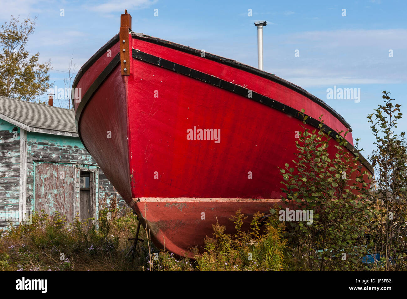 Large red fishing boat in drydock in Lubec, Maine. Stock Photo