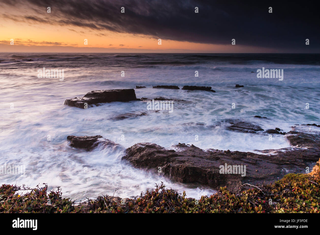Sunset with stormy weather and high surf at Point Arena Lighthouse
