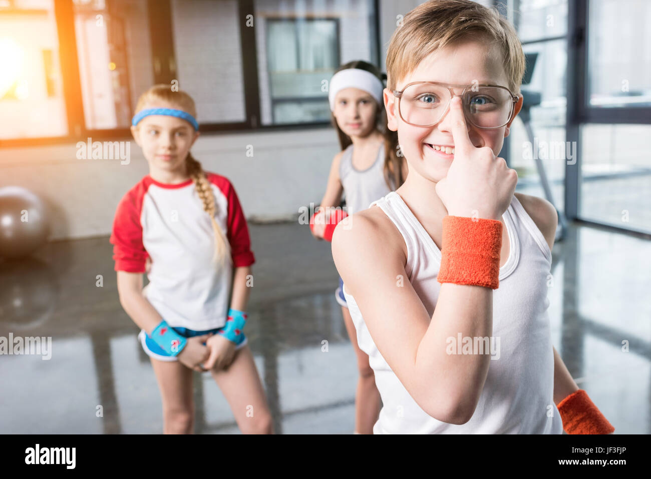 adorable kids in sportswear fooling around at fitness studio, children sport concept Stock Photo