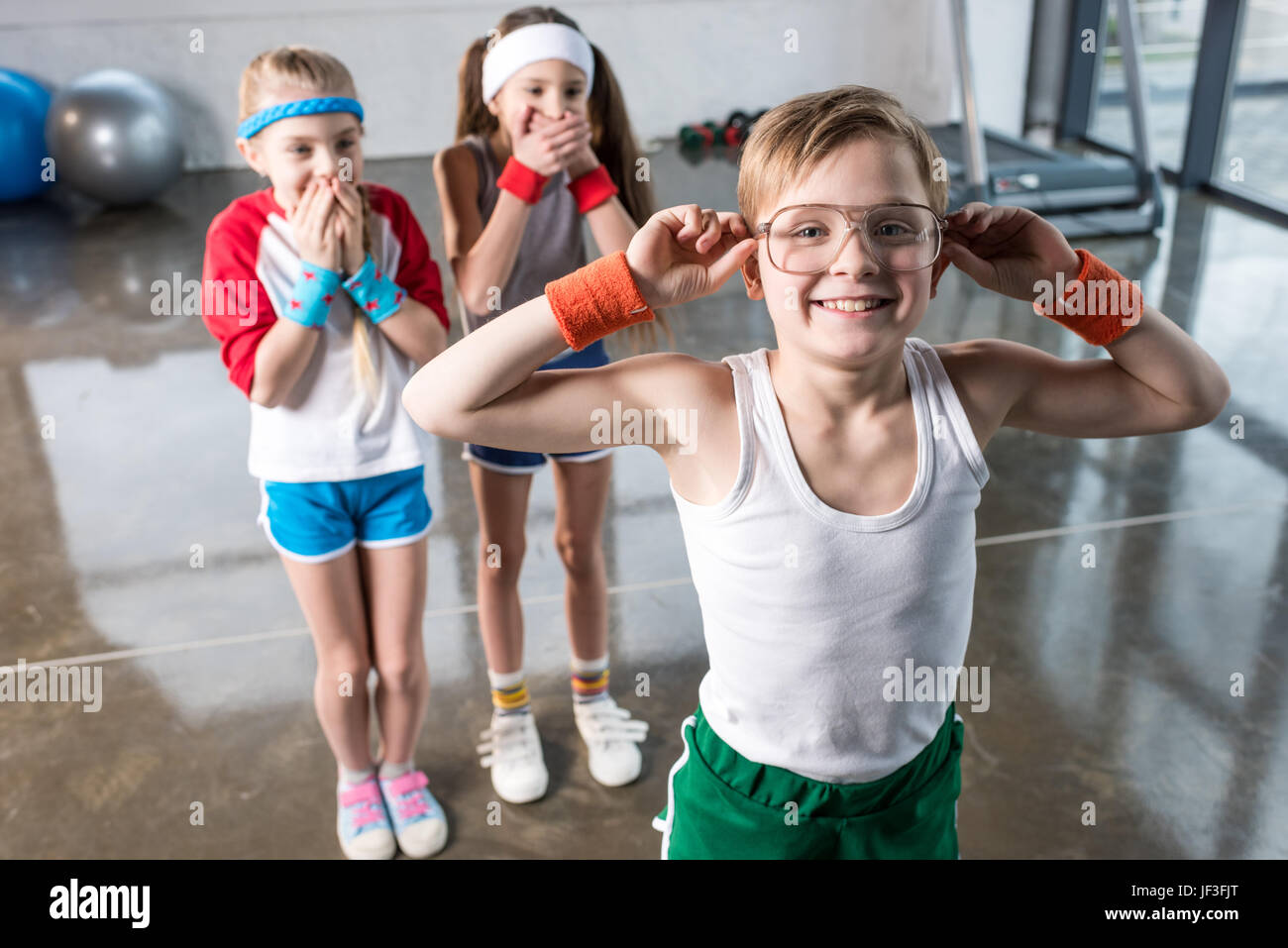 adorable kids in sportswear fooling around at fitness studio, children sport concept Stock Photo