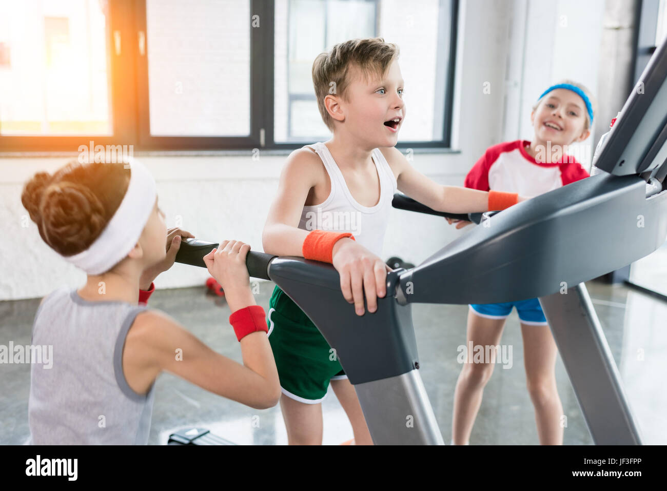 funny kids in sportswear training on treadmill at gym together, children  sport concept Stock Photo - Alamy