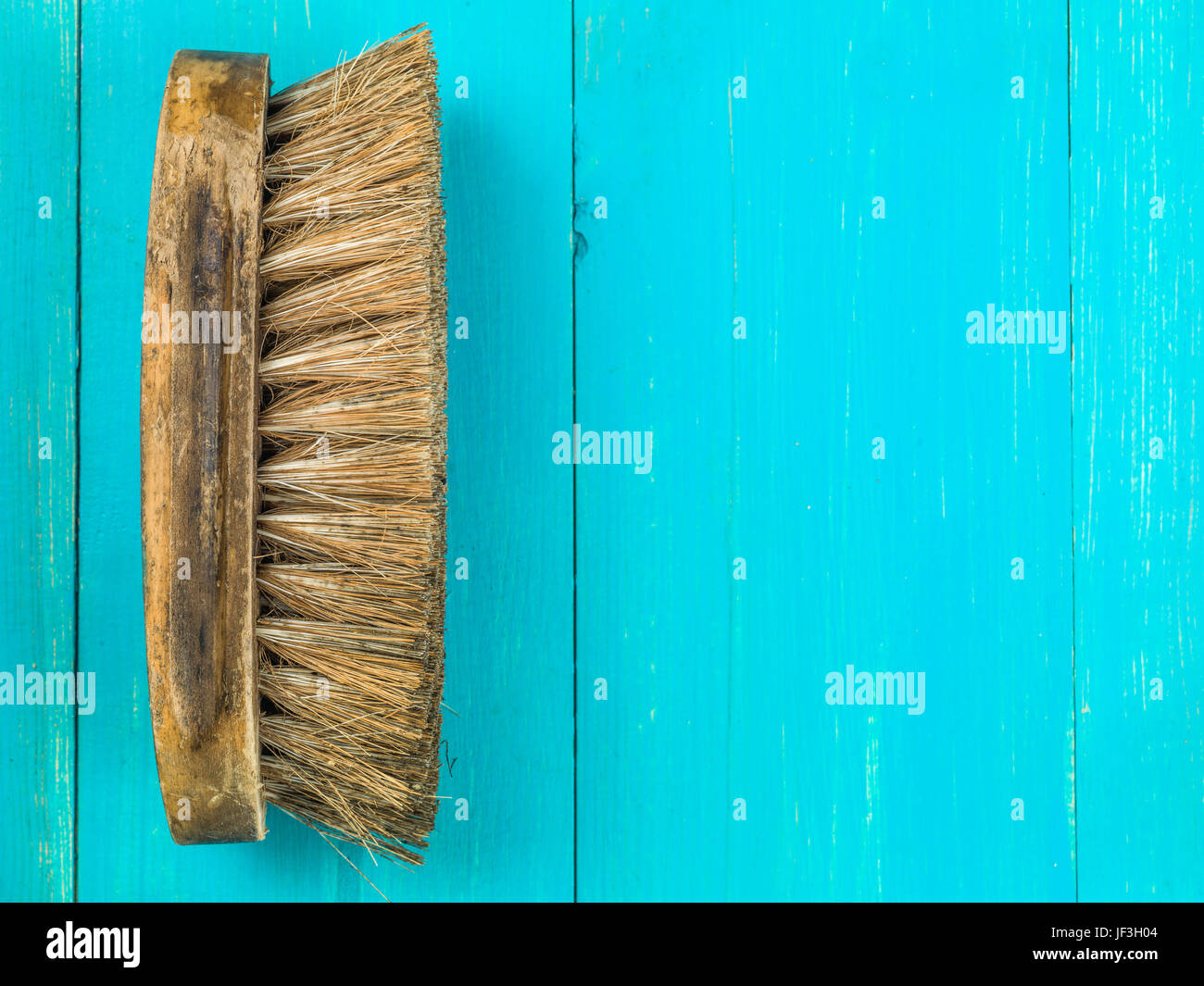 Image of a Natural Bristle Scrubbing Brush Against a Blue Background Stock Photo