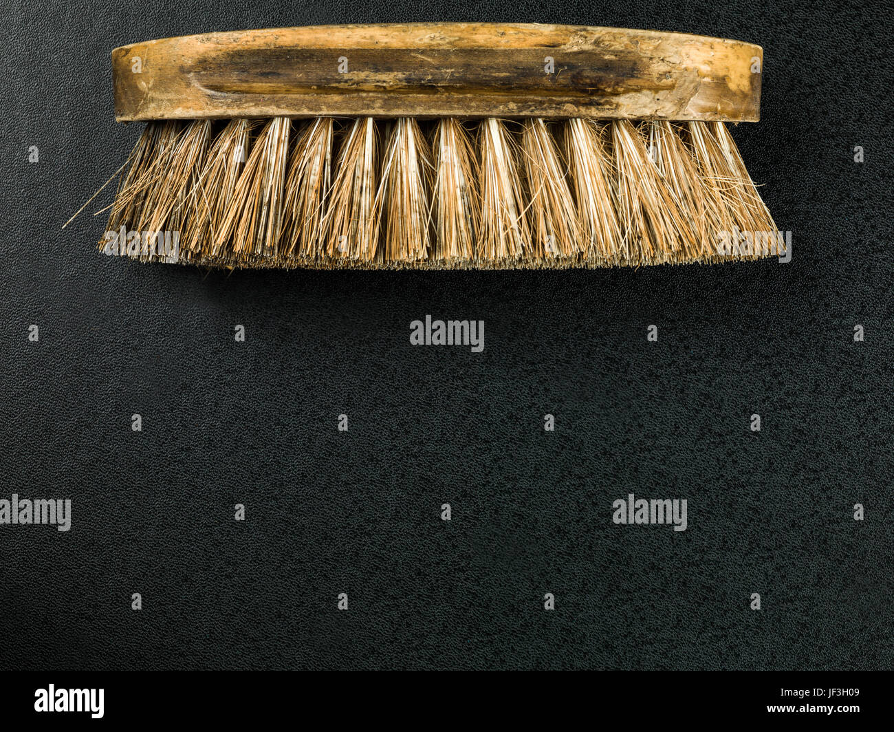 Image of a Natural Bristle Scrubbing Brush Against a Black Background Stock Photo