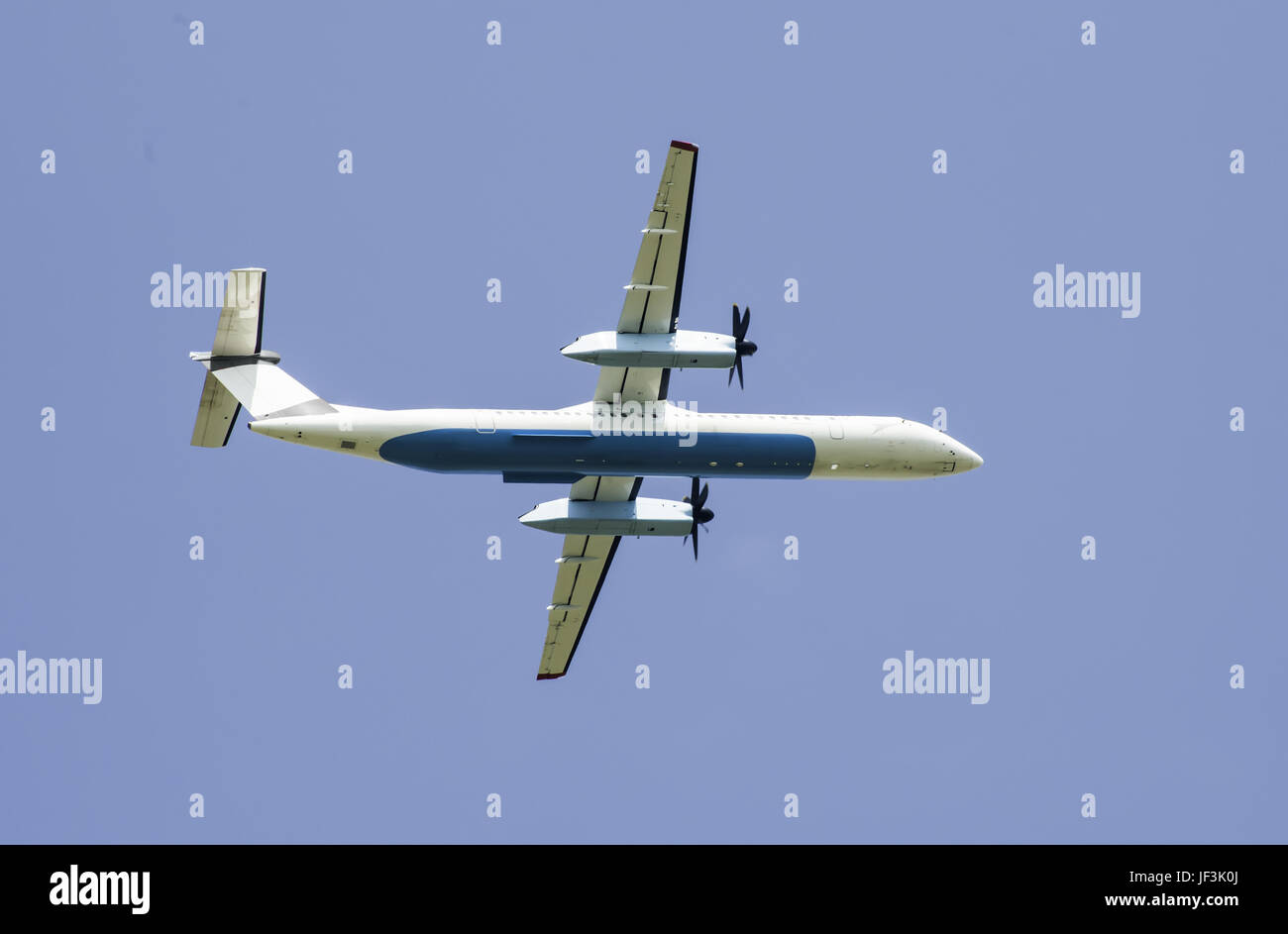Flying plane on blue sky background Stock Photo - Alamy