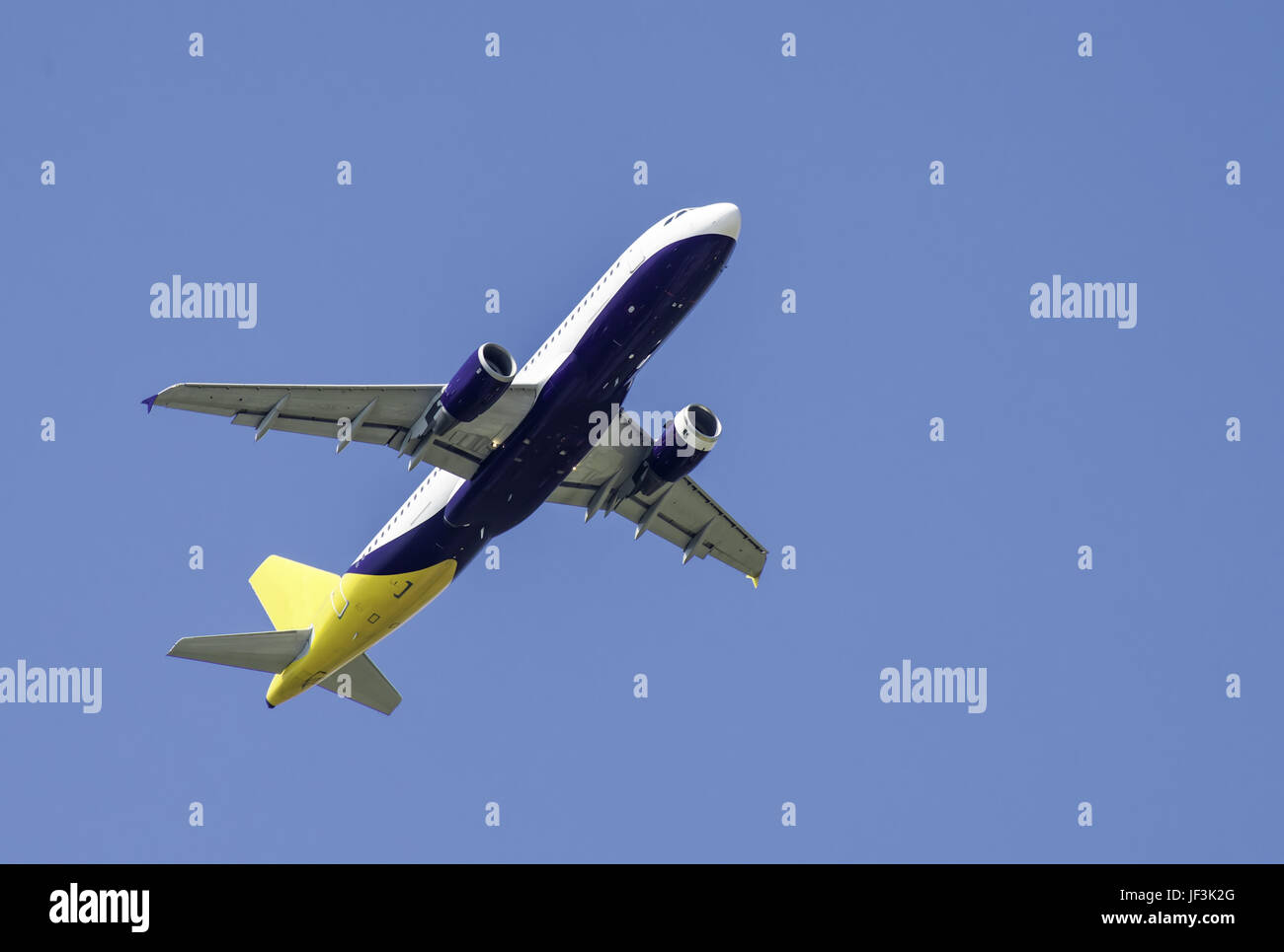 Flying plane on blue sky background Stock Photo - Alamy