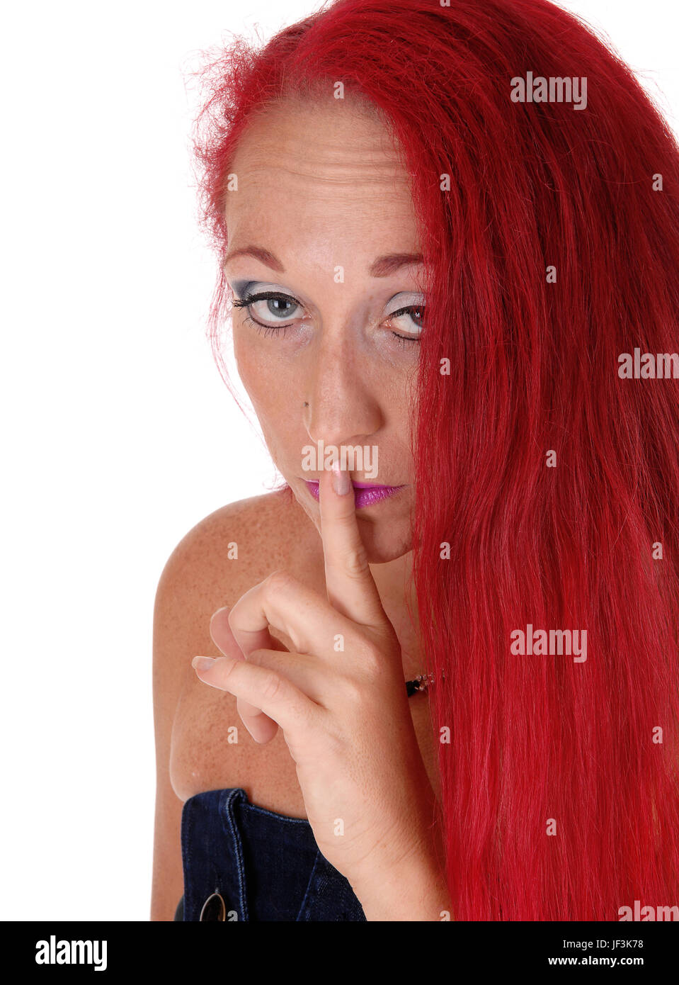 Woman with finger on mouth. Stock Photo