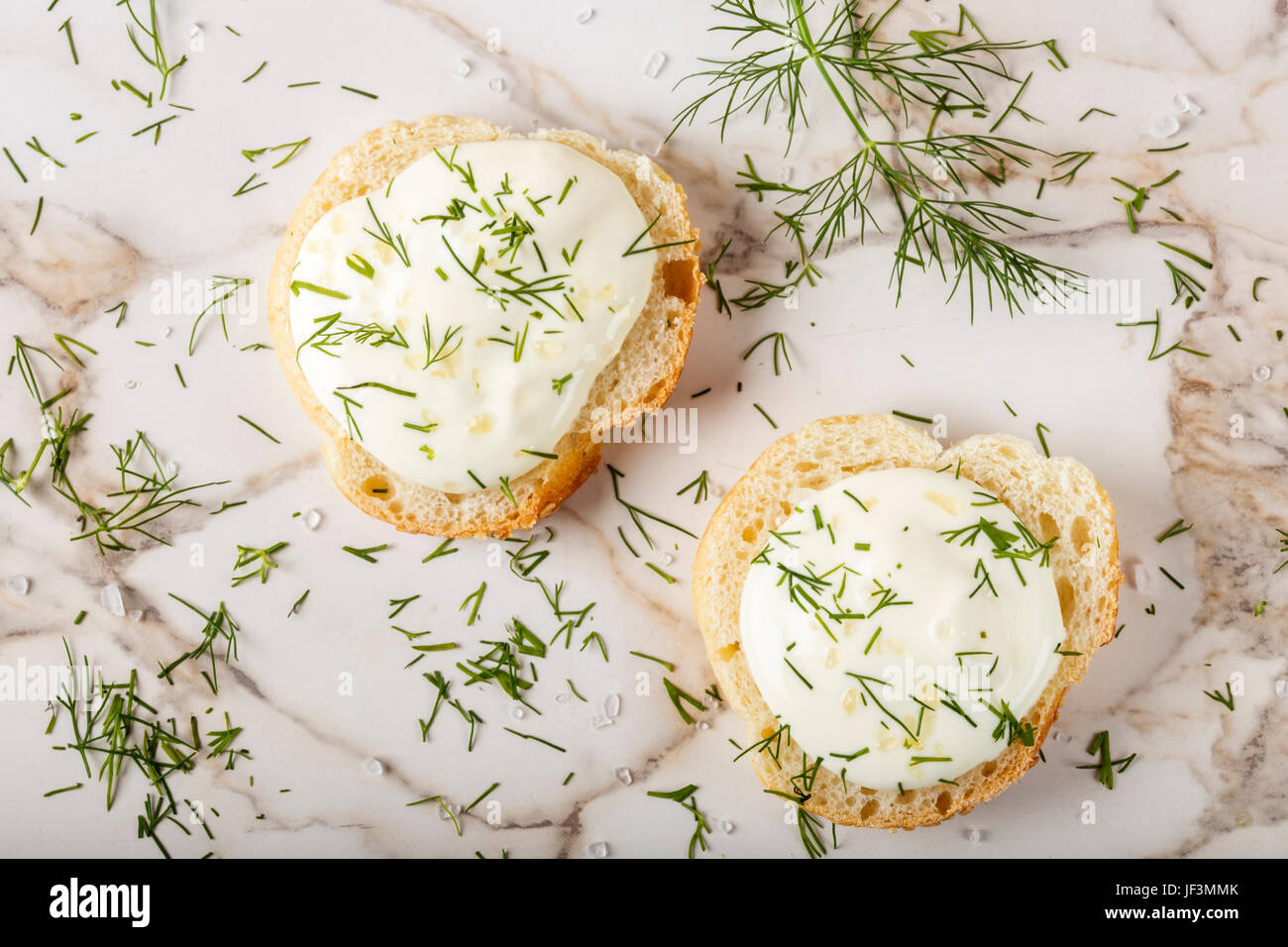 Sesame bagel with cream cheese, dill and salt on table Stock Photo Alamy