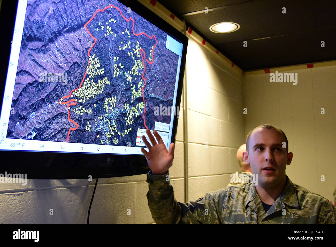 Staff Sgt. Nicholas, a member of the 236th Intelligence Support, presents a map of the wild fires in east Tennessee on Jan. 7, 2017 a Berry Field Air National Guard base in Nashville, TN. The 236th IS provided valuable imagery and mapping support to the Tennessee Emergency Management Agency and other civilian agencies fighting the fires. (U.S. Air National Guard photo by Senior Airman Anthony Agosti) Stock Photo
