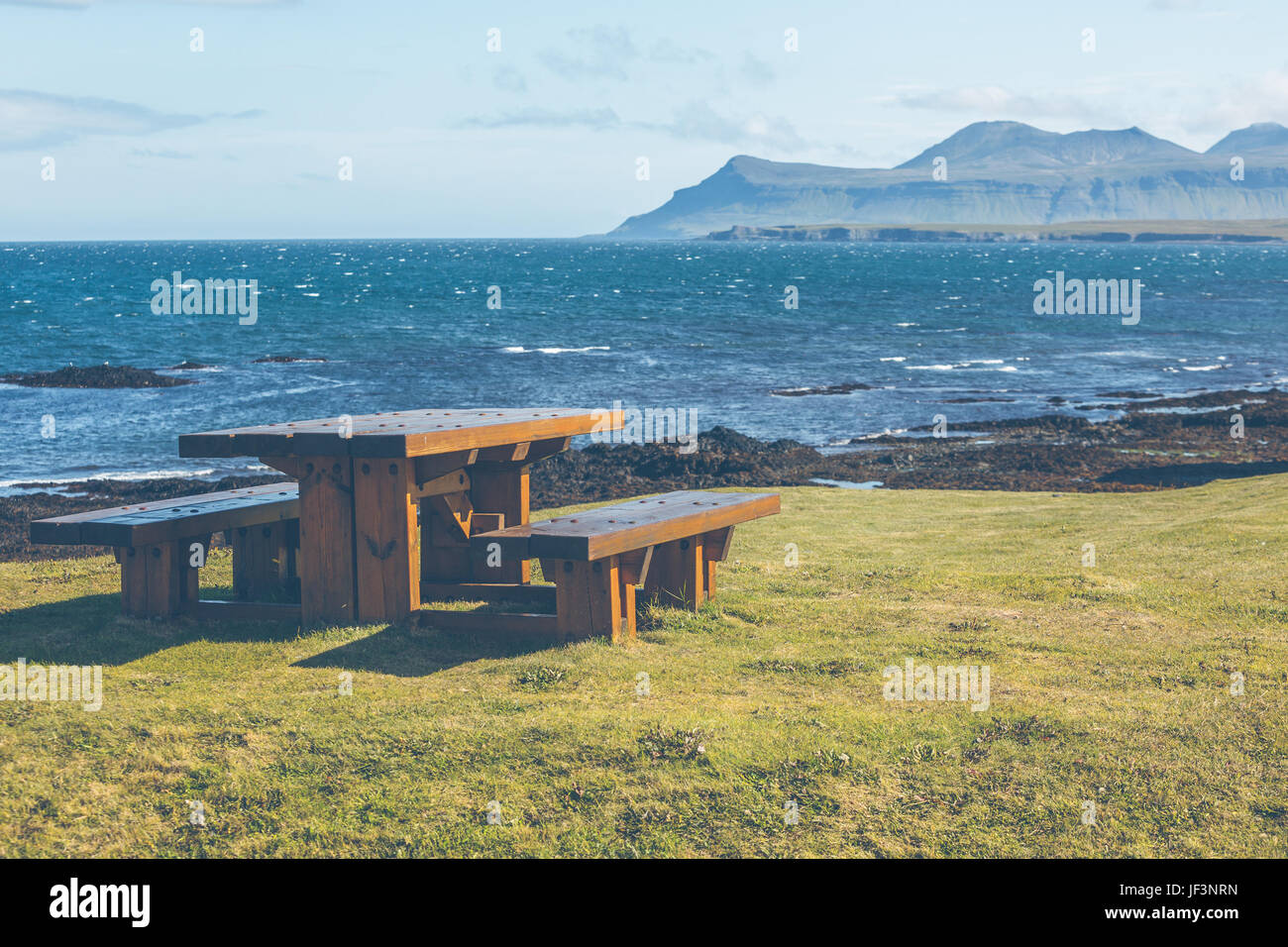 Empty Wooden table and benches in resting area at roadside Stock Photo