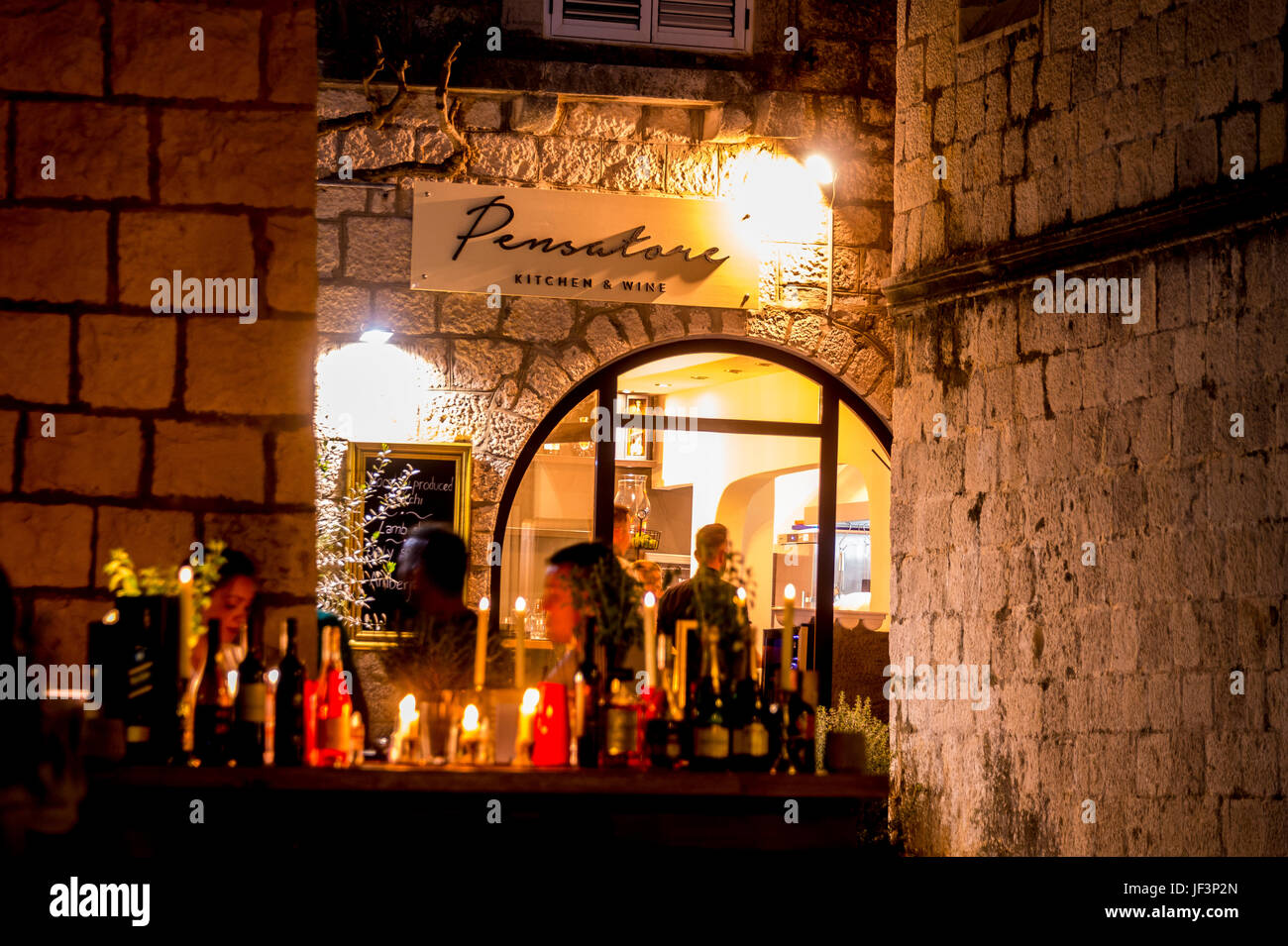 Night and the Old Town restaurants that line Zakerjan promenade on top of the East Town Wall in Old Town Korcula town, Croatia Stock Photo