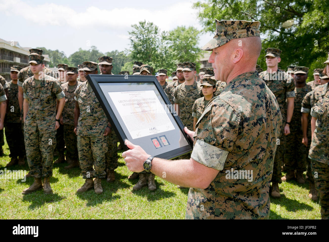 U.S. Marine Corps Sgt. Maj. Richard D. Thresher, sergeant major, II Marine Expeditionary Force (II MEF), reads the citation for the “Lt. Gen. Chesty Puller” Outstanding Leadership Award as it is being presented to the Marines and Sailors of 2nd Medical Battalion, II MEF, Camp Lejeune, N.C., May 10, 2017. The battalion earned this award for exceptional professional ability, superior performance and dedication to supporting the mission of the II MEF. (U.S. Marine Corps photo by Sgt. Kelly L. Street) Stock Photo