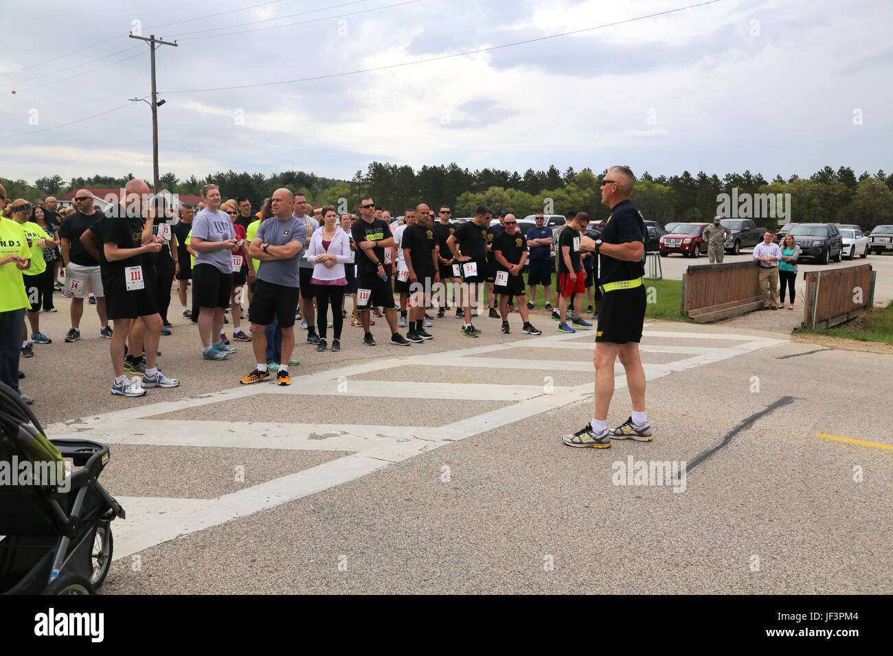 Garrison Commander Col. David J. Pinter Sr. provides opening remarks to runners from the installation community prior to a 5k run/2-mile walk at Rumpel Fitness Center on May 17, 2017, as part of the 2017 Fort McCoy Wellness Fair. Attendees to the fair not only participated in the run/walk, they also visited dozens of information displays featuring products and services from local businesses and post agencies. The American Red Cross also held a blood drive, and many door prizes were given to fair attendees. The fair, organized by the Directorate of Family and Morale, Welfare and Recreation, bro Stock Photo
