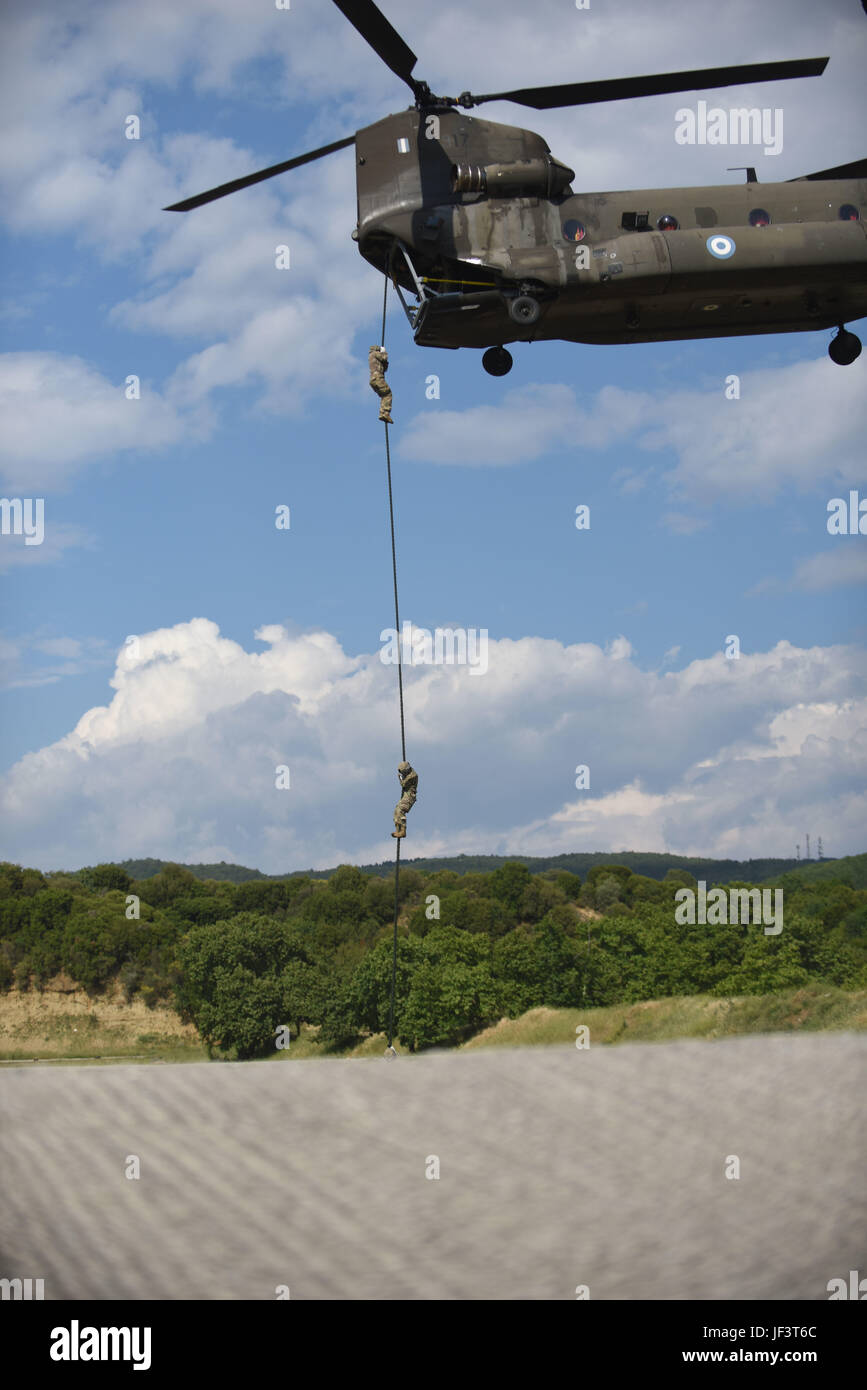 U.S. and Greek paratroopers perform fast rope training from helicopters ...