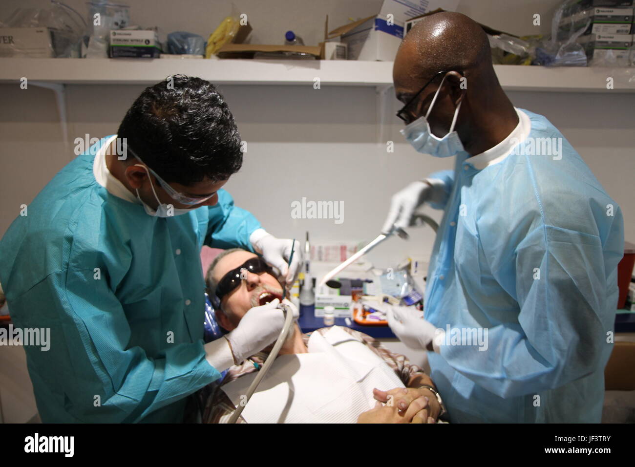 Capt. Aswini Jagadeesh and Spc. Yawotse Noumedor from the 455th Dental Company in Devens Reserve Forces Training Area, Mass. conduct a dental procedure during Appalachia IRT 2017 which took place from May 14-27 at the Wise County Fairgrounds in Wise, Va. Stock Photo