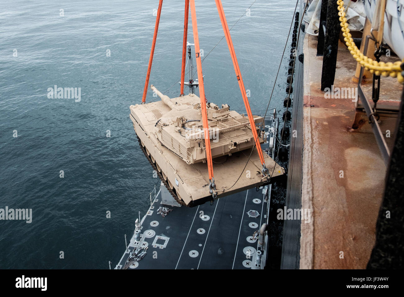 170523-N-YG116-008 BALTIC SEA (May 23, 2017) An M1A1 Abrams tank is lowered off the USNS SGT William R. Button and onto an Improvised Naval Literage System Causeway ferry, bound for the beach to participate in Operation Saber Strike 2017. Button, a Military Sealift Command Maritime Prepositioning Force Container, delivered mission-critical equipment belonging to Marine Corps Combat Logistics Regiment 45, 4th Marine Logistics Group, to the Port of Ventspils, Latvia. Saber Strike is a long-standing U.S. Army Europe-led cooperative training exercise designed to improve joint interoperability thro Stock Photo