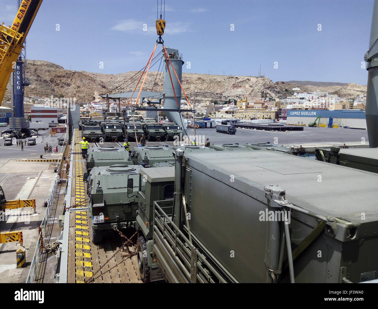 On Wednesday, May 24, in the port of Almería, material and vehicles were shipped to Romania to take part in NATO’s rapid reaction exercise Noble Jump 2017. Among the on-board material is High Tactical Mobility Vehicles (VACTAC), both for personnel and armament transport, IVECO LMV (Light Multirole Vehicle) vehicles, heavy transport trucks and light vehicles.    Troops from the Spanish Legion Brigade, a unit of the Spanish Army and Spain’s Rapid Reaction Force, will join forces with nine other NATO nations, led by the UK, to form the land component of NATO’s Very High Readiness Task Force (VJTF Stock Photo