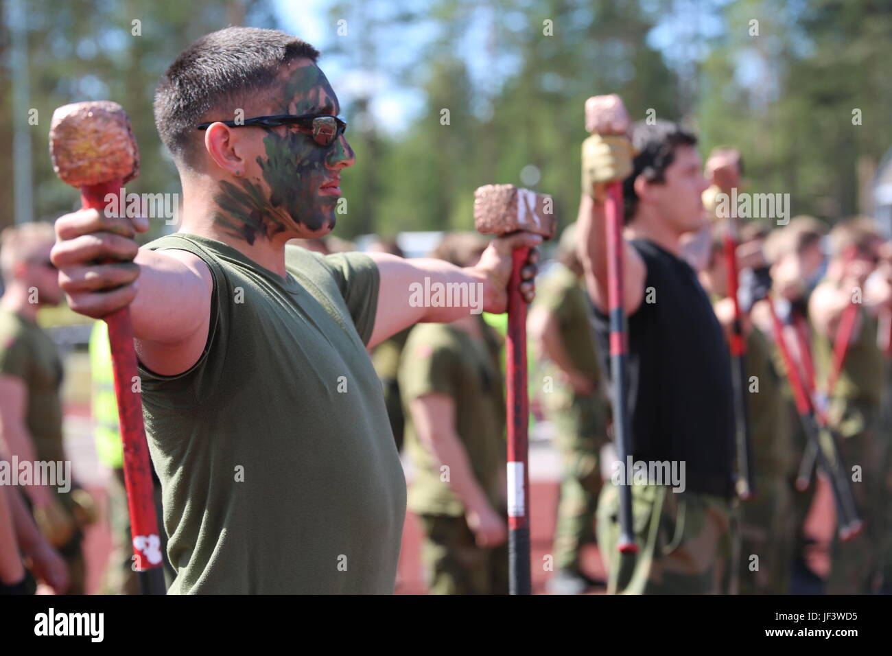 U.S. Marine Cpl. Eduardo Duran-Espino, an infantryman with Marine Rotational Force Europe 17.1, holds two hammers during the Viking Challenge, May 24, at Rena Leir, Norway. The timed hammer strength event was the first of many during the Norwegian Telemark Battalion’s annual competition. After working with Telemark Bn. During Joint Viking, the Marines were invited to participate in the elite warrior festival. (U.S. Marine Corps photo by Staff Sgt. Michele Hunt) Stock Photo
