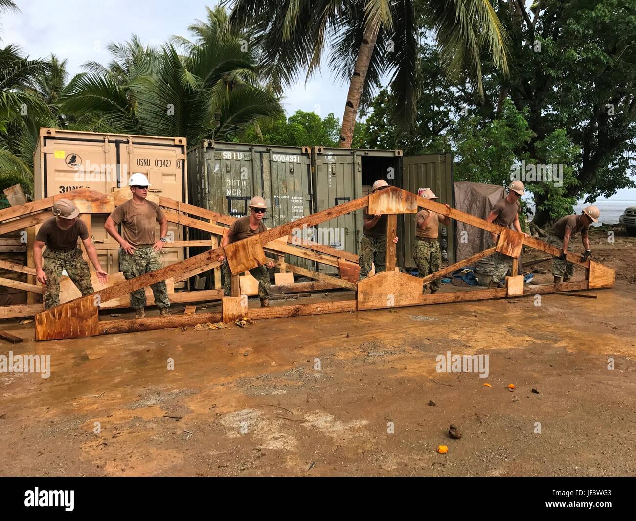 KOSRAE, Federated States of Micronesia (May 24, 2017) Seabees assigned to Naval Mobile Construction Battalion (NMCB) 1 prepare to install rafters on the Walung Health Clinic project in Kosrae, Federated States of Micronesia, May 24, 2017. NMCB 1 is forward deployed to execute construction, humanitarian and foreign assistance, special operations combat service support, and theater security cooperation in support of U.S. Pacific Command. (U.S. Navy photo by Utilitiesman Constructionman Matthew Konopka) Stock Photo