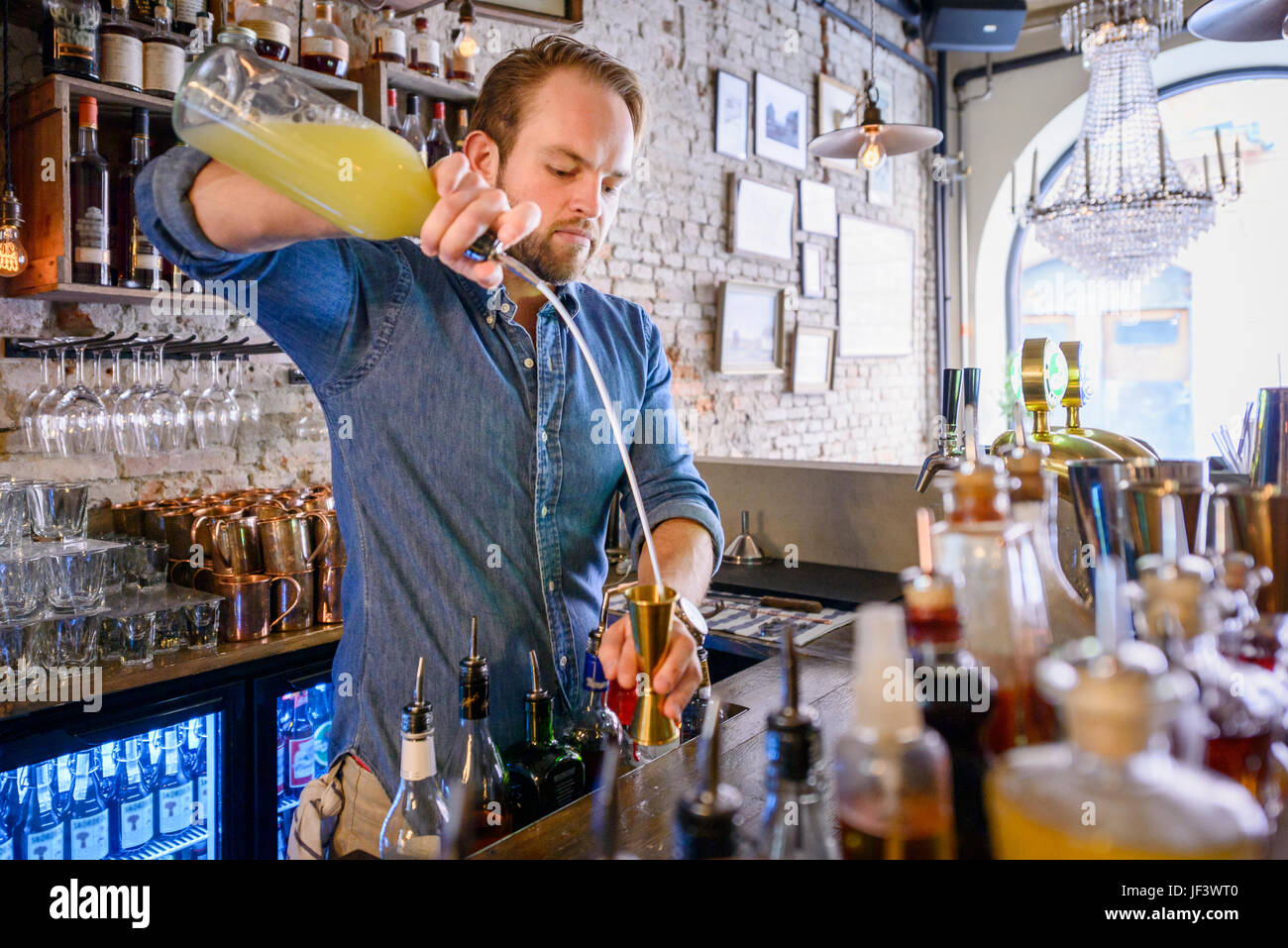 Barman preparing drink behind bar Stock Photo Alamy