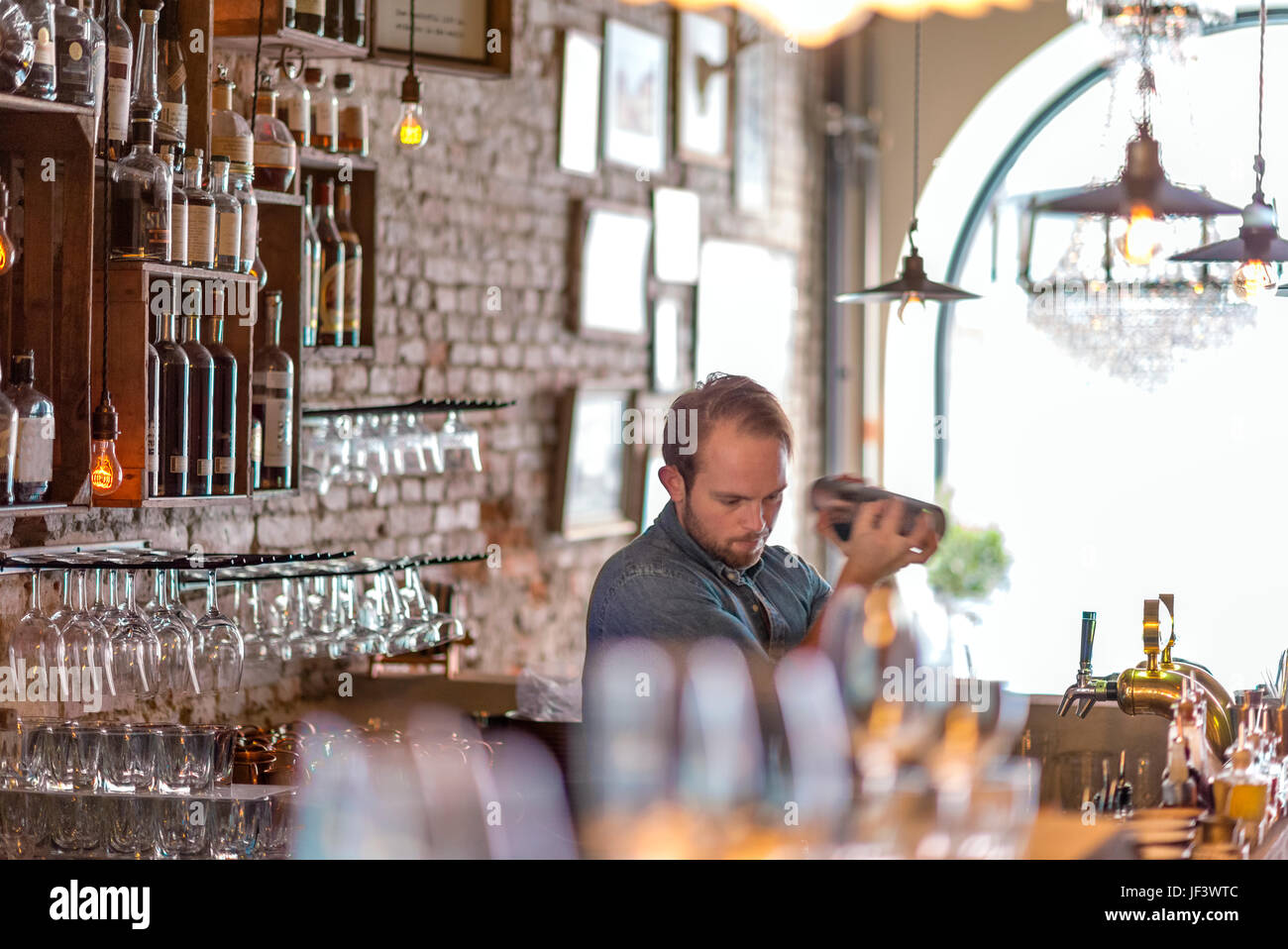 Barman preparing drink behind bar Stock Photo Alamy