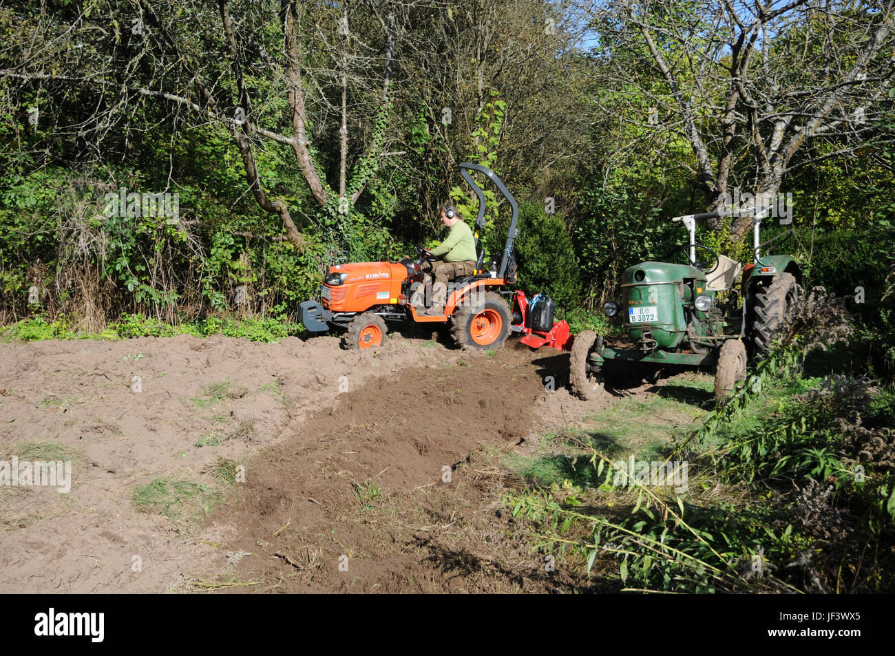 Soil tilling with tractor Stock Photo Alamy