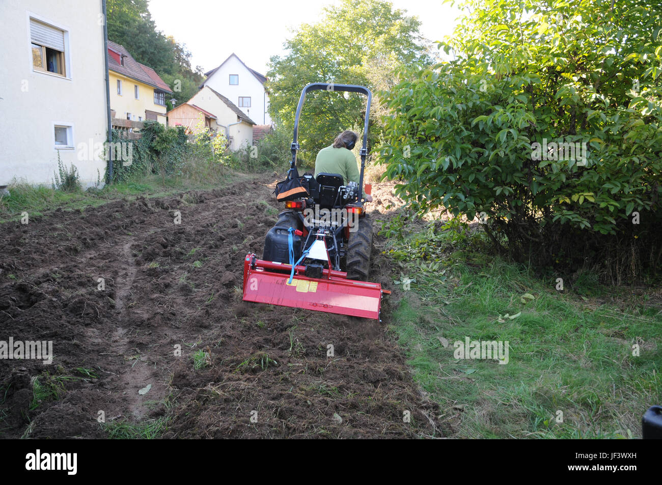 Soil tilling with tractor Stock Photo Alamy