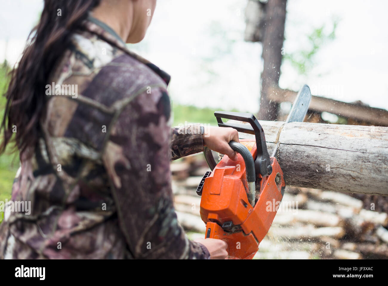 Woman using chainsaw Stock Photo Alamy