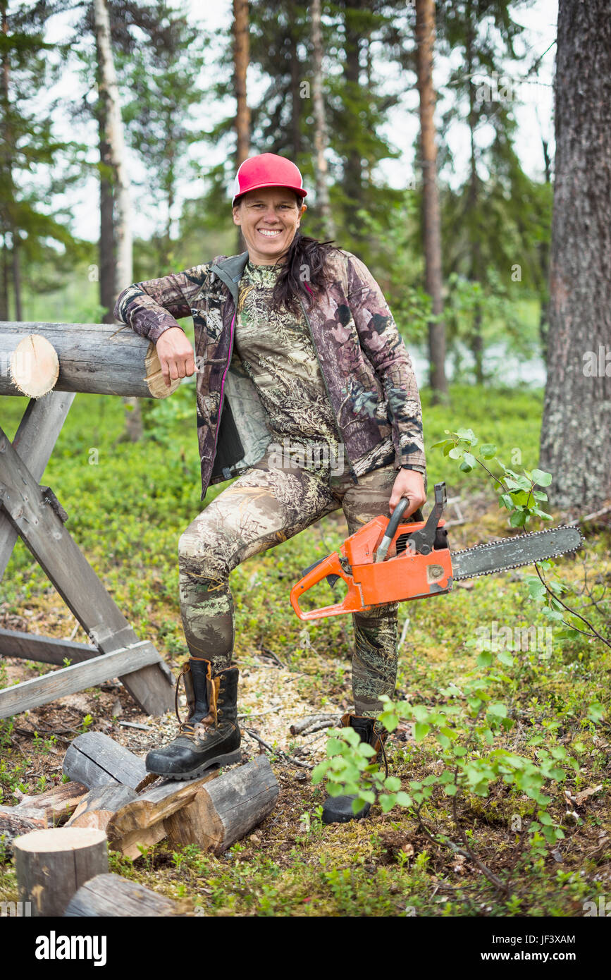 Woman with chainsaw Stock Photo - Alamy