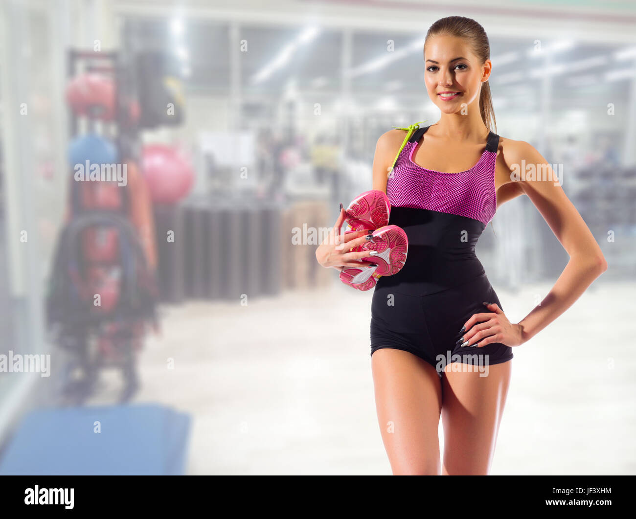 Young sporty girl in gym club Stock Photo