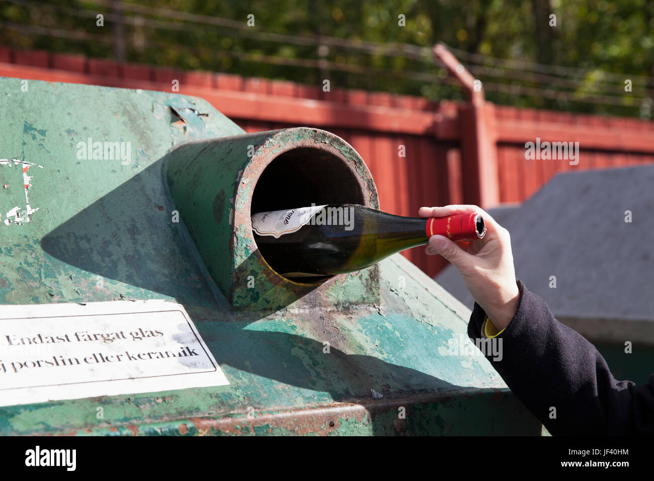 Hand putting bottle in recycling bin Stock Photo Alamy