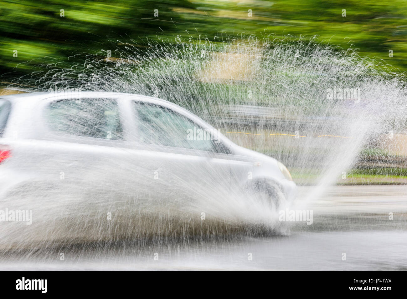 Car splashing water on road Stock Photo Alamy
