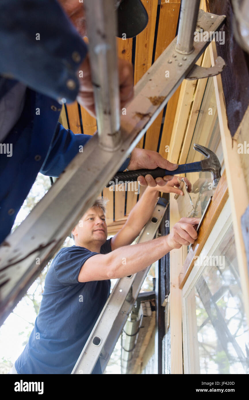 Men repairing window Stock Photo - Alamy