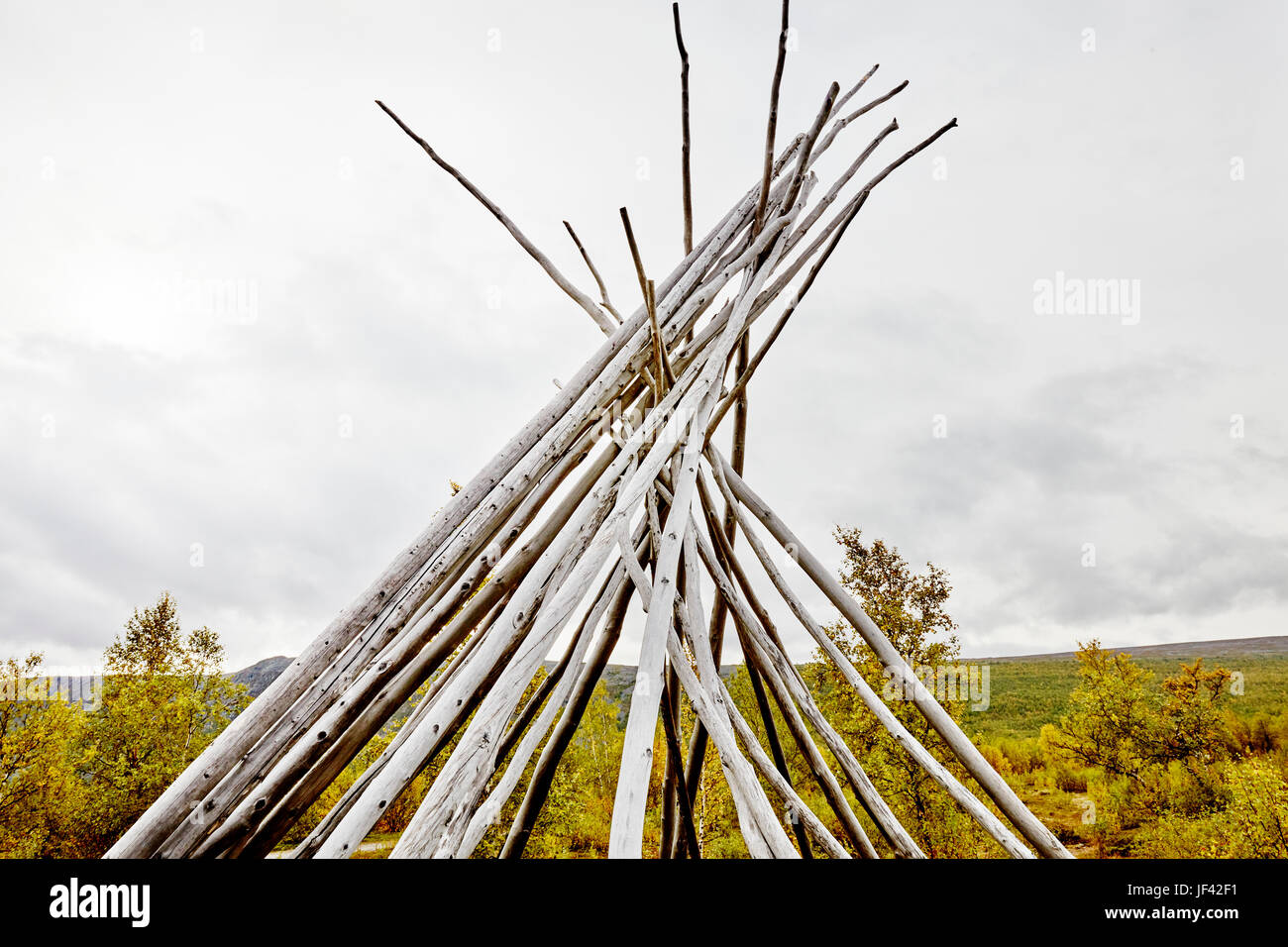 Teepee-shaped log structure Stock Photo