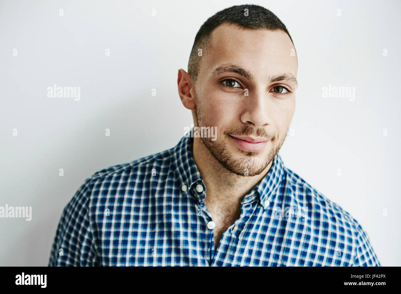 Young man looking at camera Stock Photo - Alamy