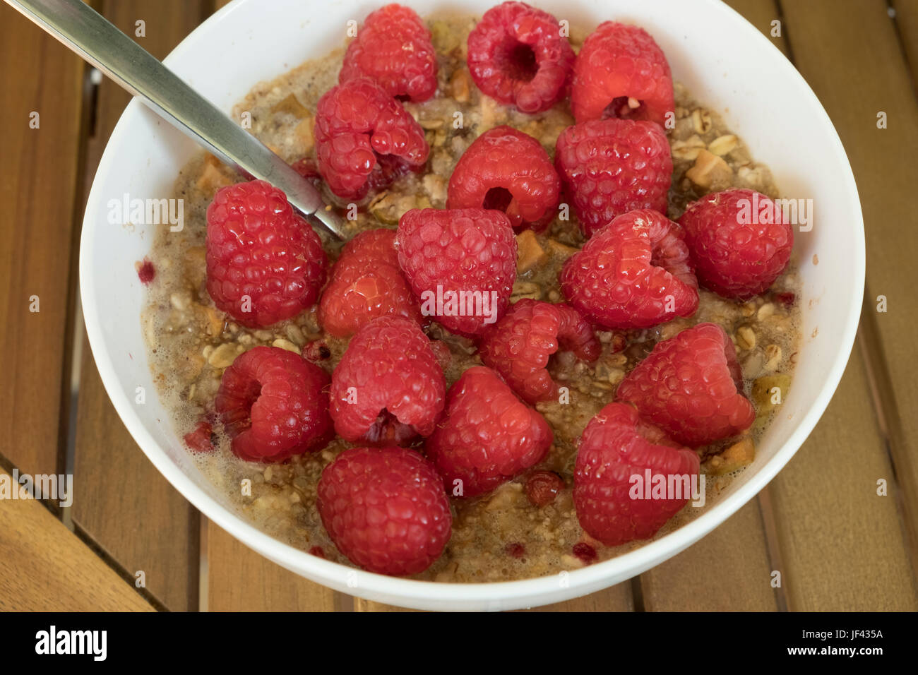 Myseli Raspberry Muesli with raspberries in a porcelain bowl and spoon Stock Photo - Alamy