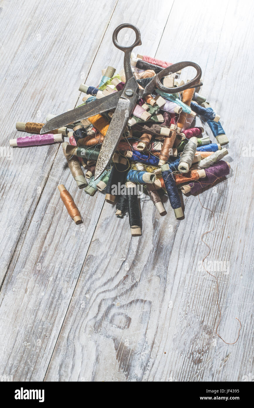 Sewing threads and scissors Stock Photo - Alamy