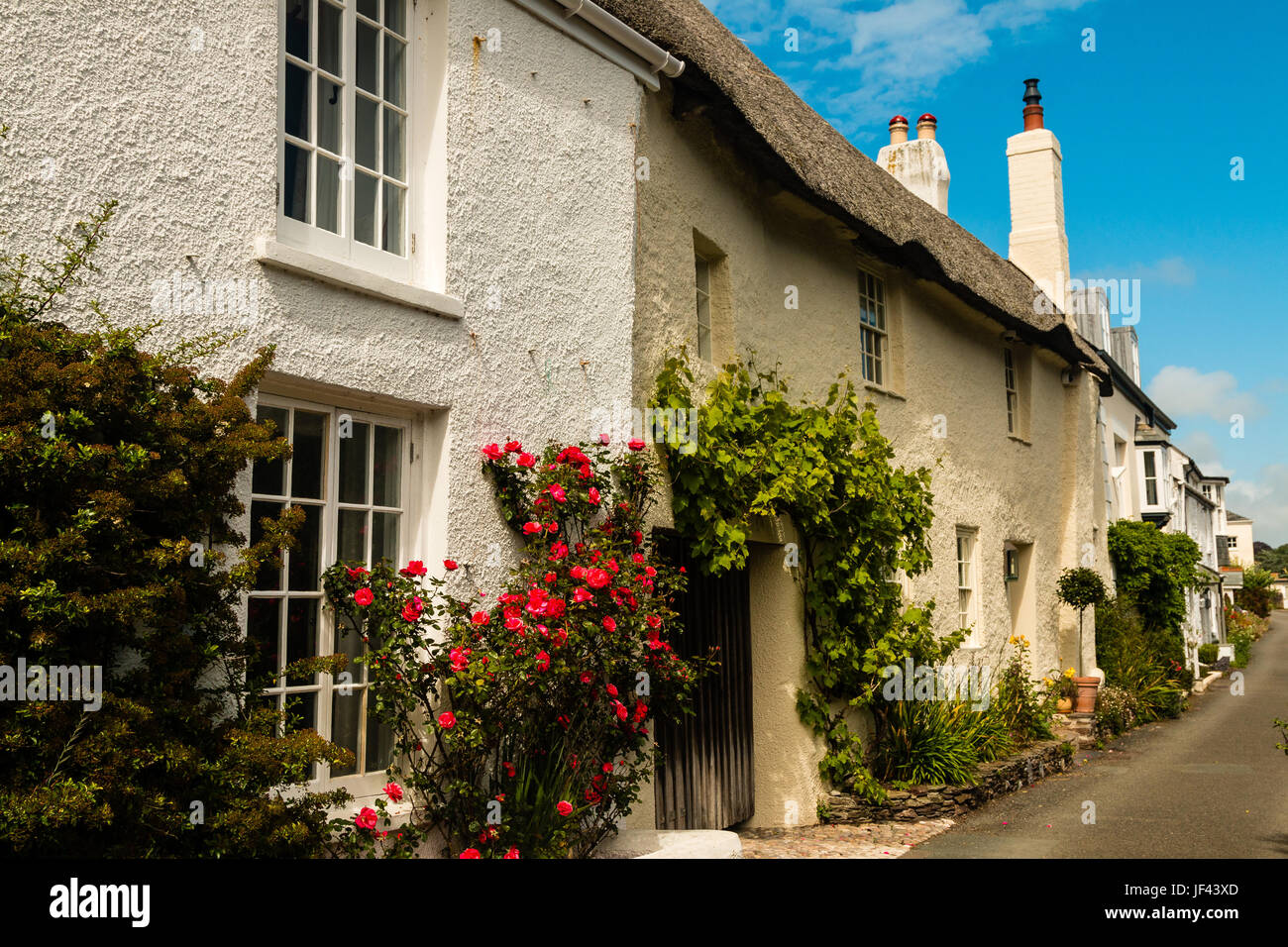 Row of pretty chocolate box cottages in the village of Noss Mayo
